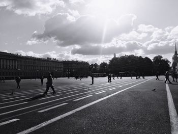 People at town square against sky on sunny day