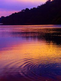 Scenic view of lake at sunset