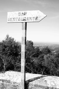 Road sign against sky