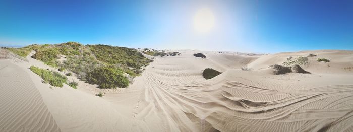 Scenic view of desert against clear blue sky