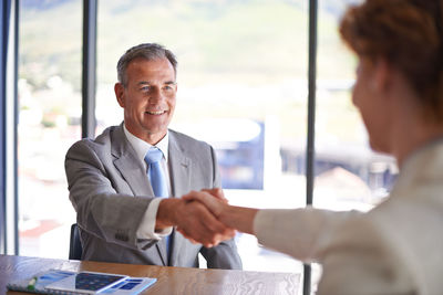 Business people shaking hands in office