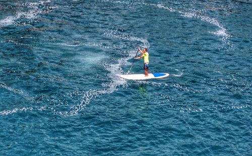 Low angle view of woman surfing in sea