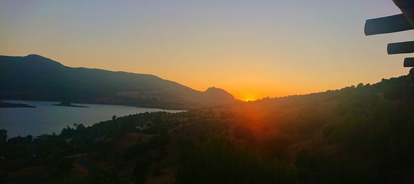 Scenic view of silhouette mountains against sky during sunset