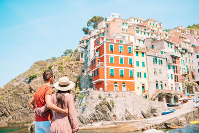 Couple standing against building in town