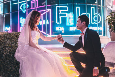 Woman with text on wall at night