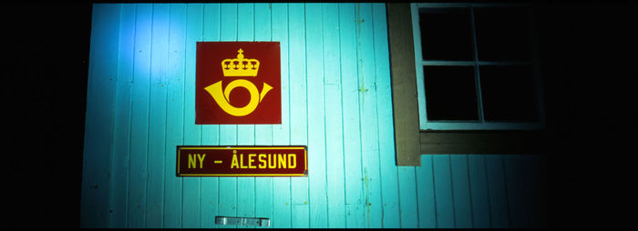 Close-up of information sign on wall