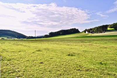 Scenic view of golf course against sky