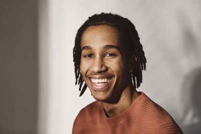 Portrait of happy young man over white background in studio