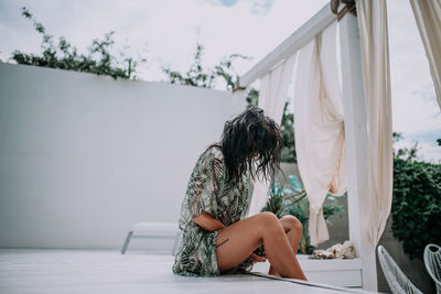 Woman sitting in yard