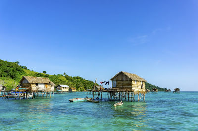 Gazebo by building against blue sky