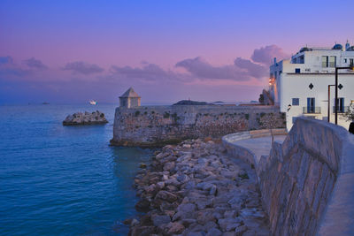 Blue hour at the breakwater of the port of ibiza.