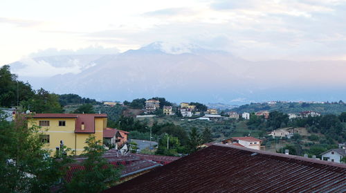 Houses in town against sky