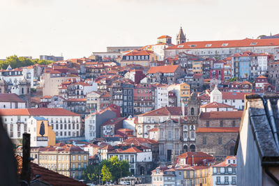 Buildings in city against clear sky