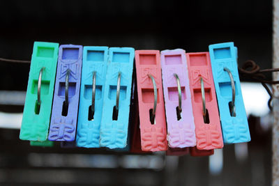 Close-up of clothespins hanging on clothesline