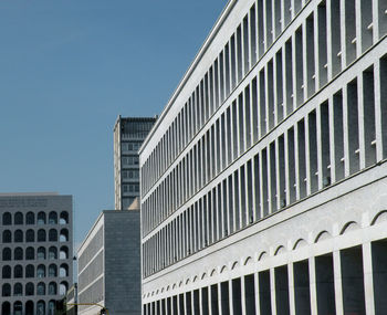 Low angle view of modern building against clear blue sky