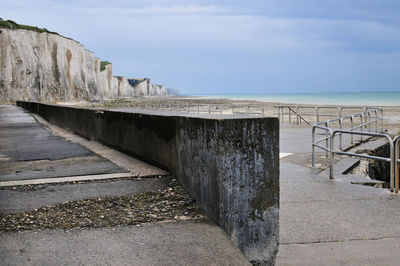 Built structure on beach against sky