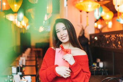 Portrait of a smiling young woman wearing mask