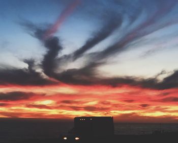 Scenic view of dramatic sky over sea during sunset