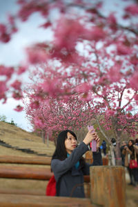 Woman photographing in park