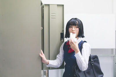 Woman standing against wall