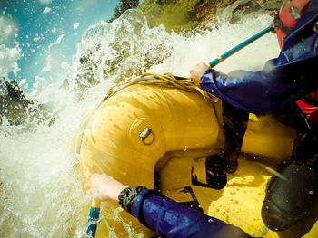 High angle view of people white water rafting in river