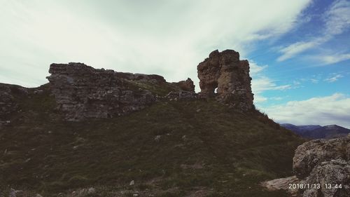 Built structure on cliff against sky