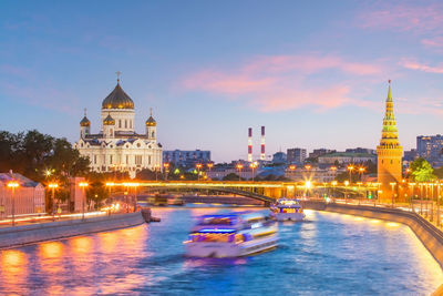 View of illuminated buildings in city against sky