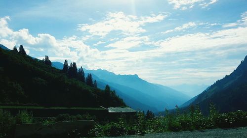 Scenic view of mountains against blue sky