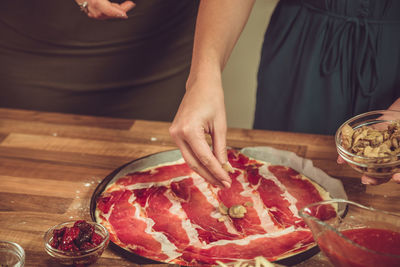 High angle view of woman preparing food on table