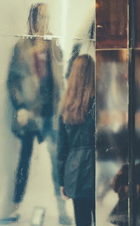 Close-up of hand on glass window