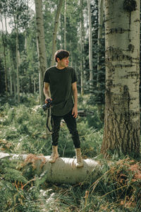 Full length of man standing in forest