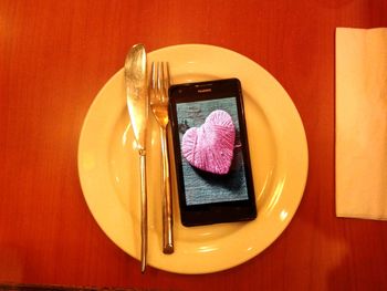 High angle view of smart phone on table