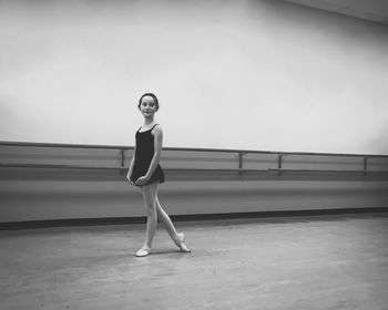 Side view of girl practicing ballet at studio