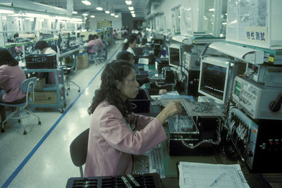 Side view of people working at shop