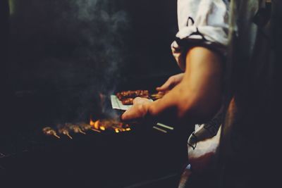 Midsection of man preparing food