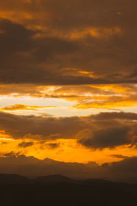 Scenic view of dramatic sky during sunset