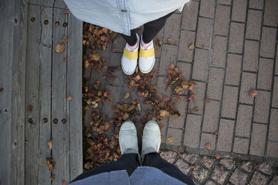 Low section of people standing on footpath