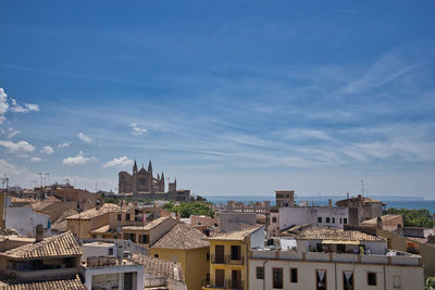 Buildings in city against blue sky