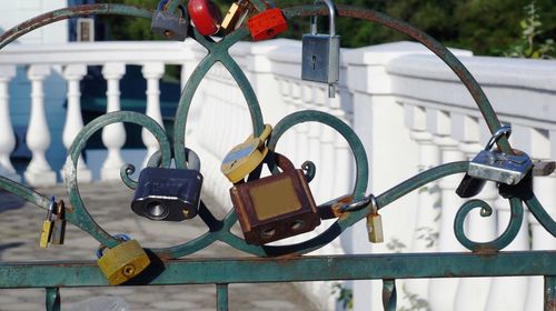 Close-up of love locks hanging on gate