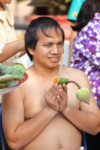 Portrait of a young woman holding food