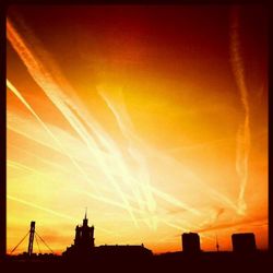 Low angle view of buildings against sky at sunset