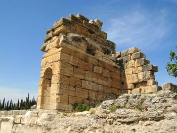 Low angle view of historical building against blue sky