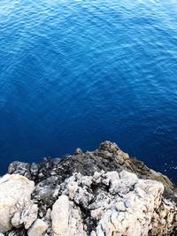 High angle view of rock formation in sea