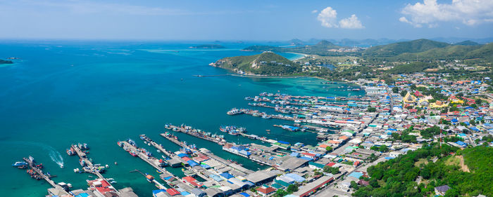 High angle view of cityscape by sea against sky