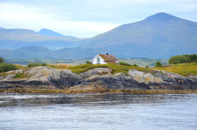 Rocky fjord landscape and an isolated house in norway