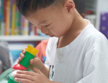 Close-up of boy with toy playing at home