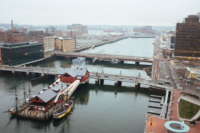 High angle view of boats moored by bridges at lake in city