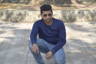 Portrait of young man sitting outdoors