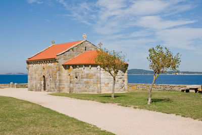 Building by sea against sky