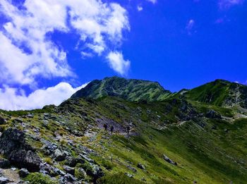 Scenic view of mountains against blue sky